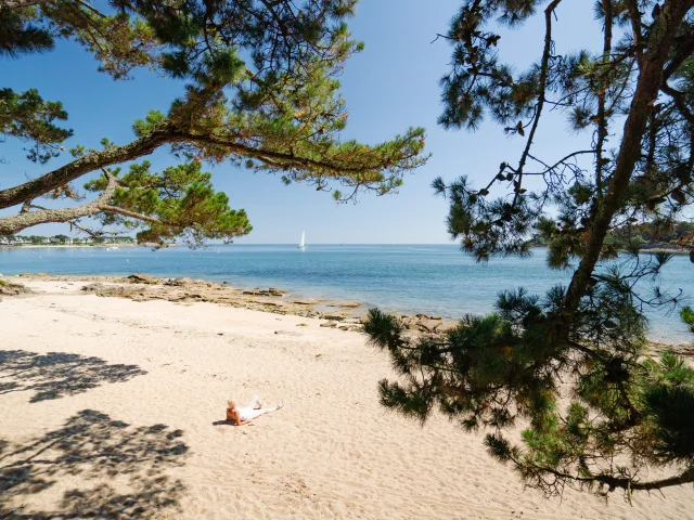 Woman sunbathing on Plage du Coq