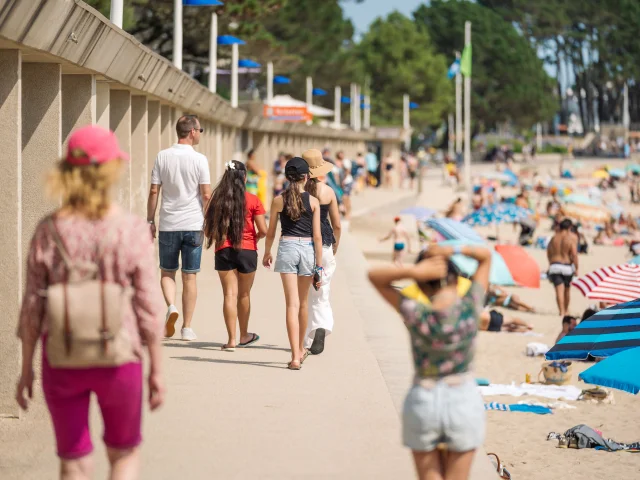 Family walk along the Plage du Trez near the beach huts