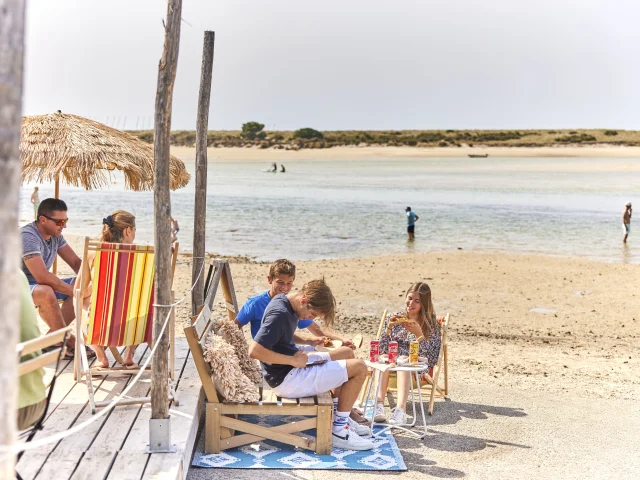 Group of teenagers enjoying a snack at the Paillotte on Plage du Letty