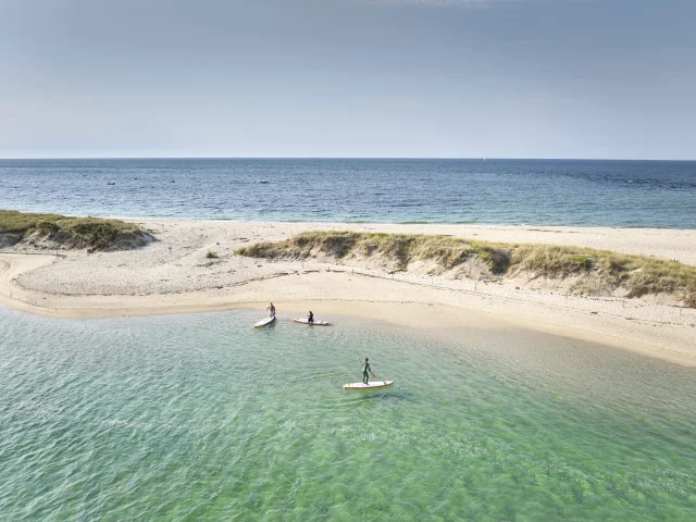Aerial view of paddleboarders near the Mousterlin Dunes