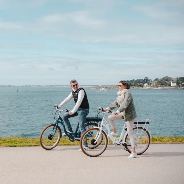 Couple cycling on the Corniche de la Mer