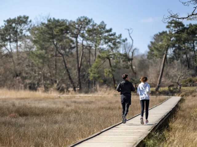 Couple running in Anse du Petit Moulin