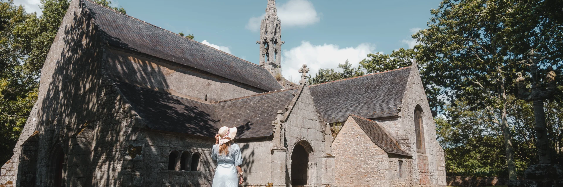 Young woman admiring the façade of the Chapelle de Perguet in Bénodet