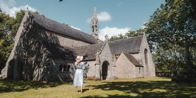 Young woman admiring the façade of the Chapelle de Perguet in Bénodet
