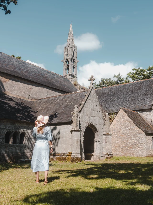 Young woman admiring the façade of the Chapelle de Perguet in Bénodet