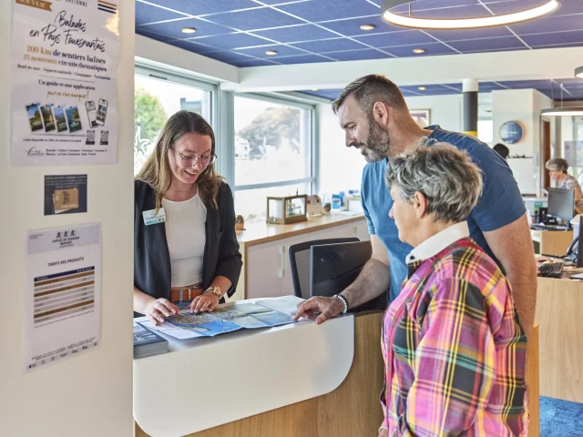 Conseillère en séjour renseignant des visiteurs à l'Office de Tourisme de Bénodet